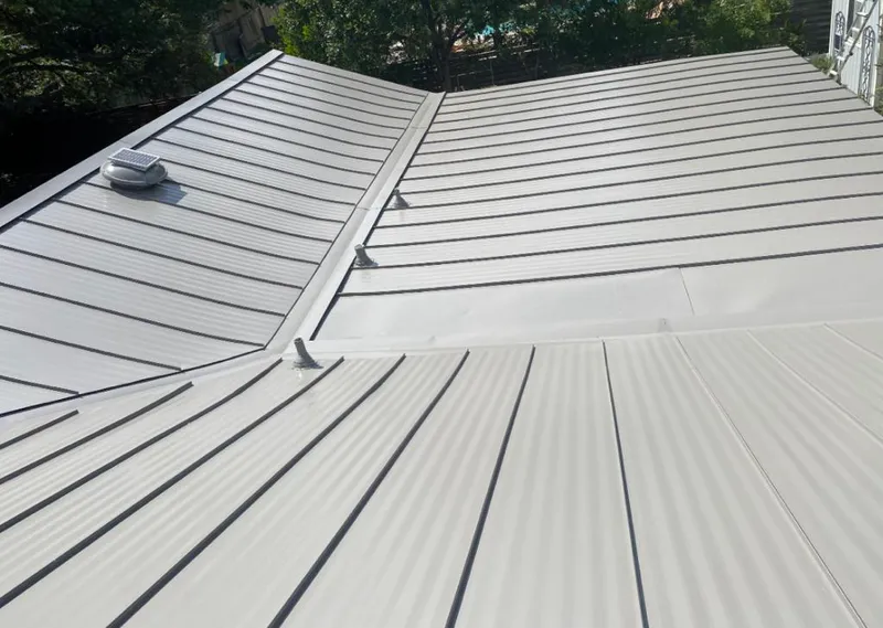 Solar attic fan installed on a metal roof for Roof Ventilation in London